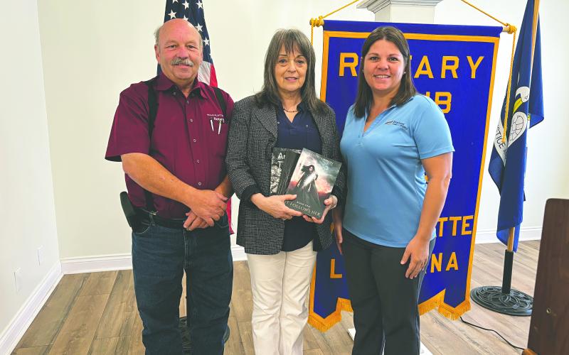 LAWSON SHARES JOURNEY AS AUTHOR - Local author Debby Lawson visited the October 8, meeting of the Ville Platte Rotary Club to discuss the publication of her latest book. She is shown with Rotary President Bob Manuel (left) and Rotary Secretary Kristi Enicke (right). (Gazette photo by Heather Bogard)