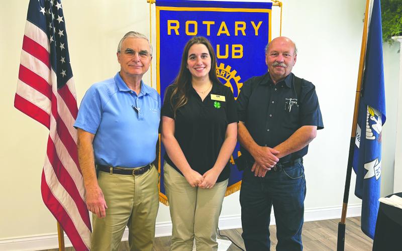 4-H OPPORTUNITIES SHARED - Evangeline Parish 4-H Agent Madison Latour visited the November 5, meeting of the Ville Platte Rotary Club. She is shown with Rotarian Dr. Kirk Soileau (left) and Rotary President Bob Manuel (right). (Gazette photo by Heather Bogard)