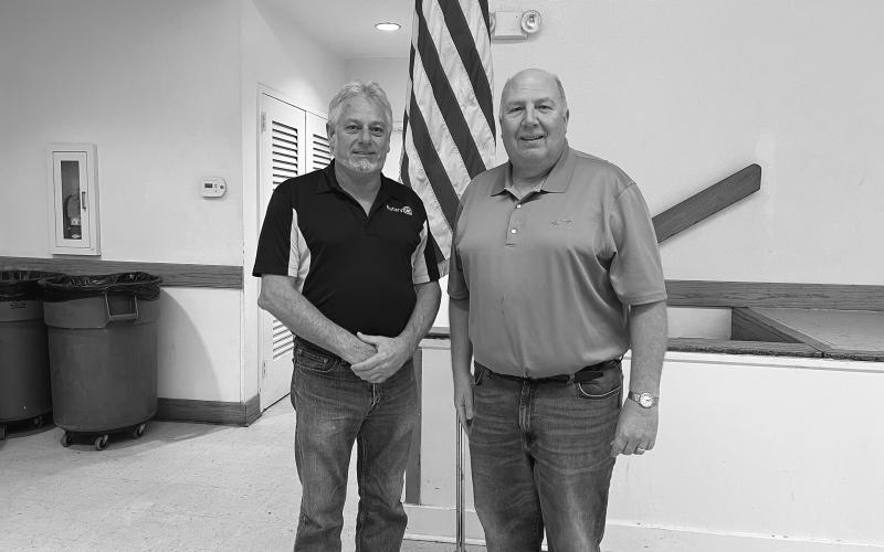 DEROUSELLE TALKS 911 SERVICES - During the December 13, meeting of the Ville Platte Rotary Club, Pat Derouselle (right) spoke with the group about 911 services in Evangeline Parish. He is shown with Rotary President Larry Lachney (left). (Gazette photo by Heather Bogard)