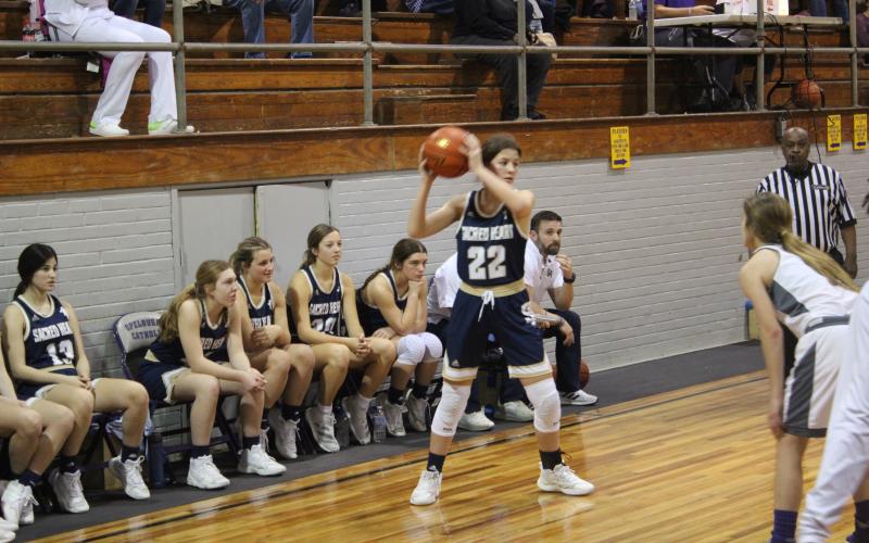 Kali Shiver (22) sets up a play for her Lady Trojans in Sacred Heart’s 47-46 road loss to Opelousas Catholic Tuesday night. (Gazette photo by Rhett Manuel)