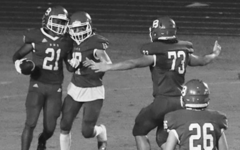 CELEBRATION - Basile’s Luke Fontenot (17) and Christian Bergeron (73) celebrate with Jared Thomas (21) following  one of Thomas’ five receptions from quarterback Luc Johnson. Ashton Deaville (26)  is in the foreground. (Photo by Nikki Johnson)