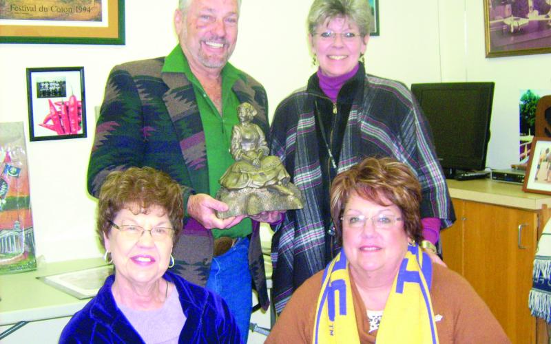In the left photo, holding the bronze Maquette of Our Evangeline is Sculptor Jerry Gorum, back row, left. Also pictured next to him is Suzy Lemoine, project chair; and in front, left to right, are Mary Alice Fontenot, tourism president; and Camille Fontenot, tourism director.