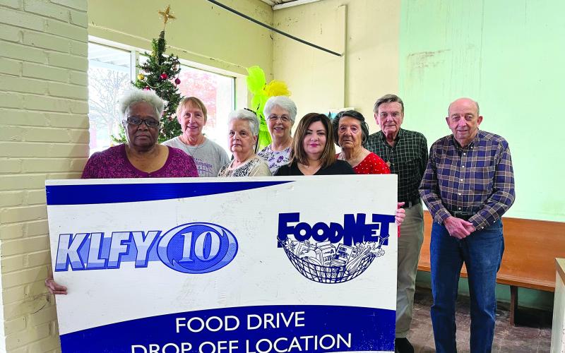 CARE AND SHARE TO PARTICIPATE IN FOOD DRIVE - Shown, from left, are volunteers Gloria Griffin, Anetta Fontenot, Becky Miller, Sharlene Znamierowski, Kaera Doucet, Ollie Bright, Eugene Fontenot, and P.L. Fontenot. (Gazette photo by Heather Bogard)