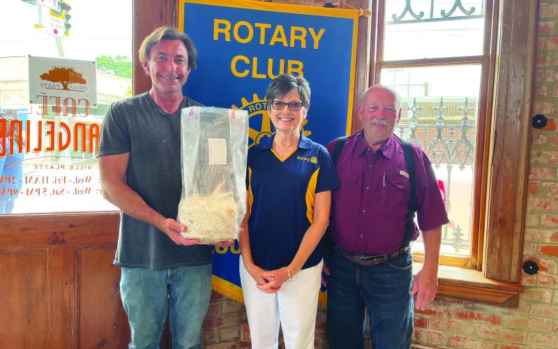 MUSHROOM GARDENING DISCUSSED - Mushroom farmer Phil Deshotel (left) holding an example of the mushrooms he grows) spoke about the gardening of mushrooms and the wide variety of mushrooms available to grow. He is shown with Rotary Treasurer Annette Johnson (center) and Rotarian Bob Manuel. (Gazette photo by Heather Bogard)