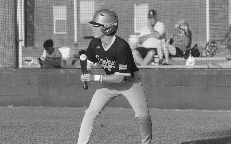 Trojan leadoff hitter and starting shortstop Gabe Wilmouth (11) attempts to lay down a bunt in Thursday’s loss to Kinder. (Gazette photo by Rhett Manuel)