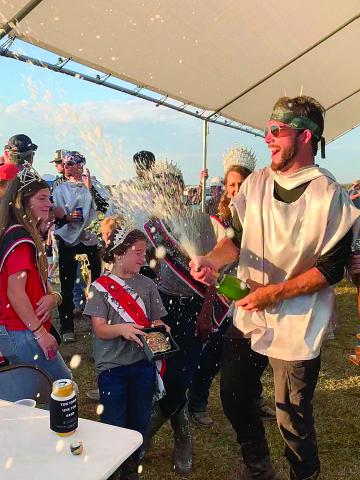 Tournoi Champion John Ross Guillory celebrates his victory with a celebratory champagne shower. For more scenes from this year’s running of the event, turn to Page 12. (Photo by Elizabeth West)