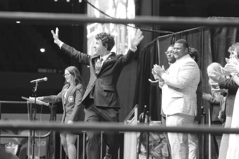 Dayton Pennington, of Avoyelles Parish, celebrates after being introduced as the new 4-H state president during an assembly at 4-H University on June 19, 2025. Looking on are, at left, outgoing president Breleigh Page, of Livingston Parish, and several other newly named officers of the organization. (Photo by Olivia McClure/LSU AgCenter)