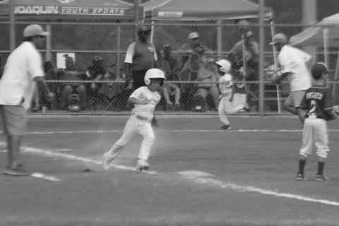 Amari Carr (9) scores on an RBI single from Emmett Lafleur (13) to give the Ville Platte 7U Coach Pitch All Stars a 4-2 lead over Shelby County in the Dixie Youth Region III World Series. Shelby County, though, won 9-8 in extra innings, on Saturday, July 22, and eliminated Ville Platte from the tournament. (Gazette photo by Tony Marks)