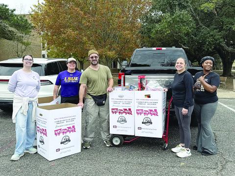Paramedic Field Supervisor Annie Dillard (second from right) with Paul Ganucheau, Toys for Tots Regional Coordinator (middle) and Toys for Tots volunteers. (Photo courtesy of Acadian Ambulance)