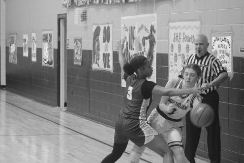 Averie Pitre (4) prevents the basketball from going out of bounds for the Lady Trojans in their win over Ascension Catholic. With the win, the team reached the quarterfinals for the second time in three years. (Gazette photo by Tony Marks)