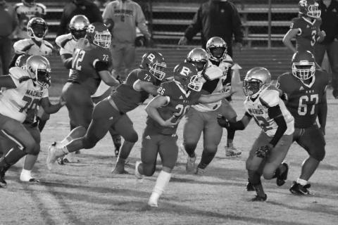 Ashton Deville (26) runs right at a Magnolia defender while Christian Bergeron (73) and Anphrony Guillory (67) play their respective roles in Basile’s galloping round one playoff win last week. (Photo by Nikki Johnson)