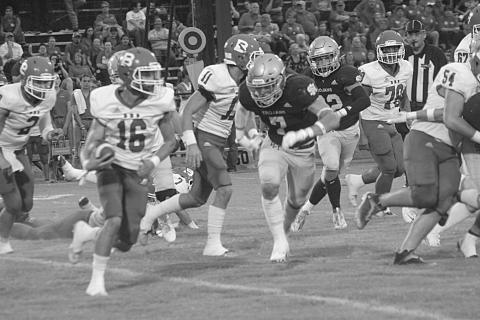 Trojan linebacker Cole Tate (7) goes in for a tackle on Basile’s wide receiver Gage Craton (16). (Gazette photo by Rhett Manuel)