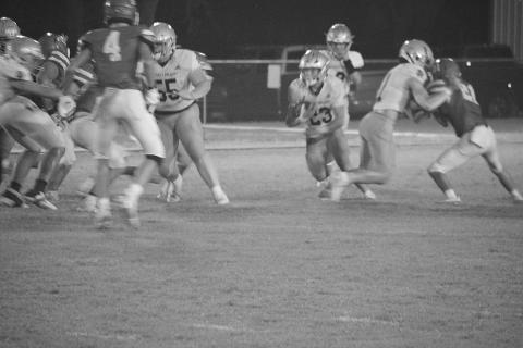 Kolton Lafleur (55) provides a block letting Jude Hebert (23) find some running room in Sacred Heart’s 17-14 win over Basile. (LSN photo by Rhett Manuel)