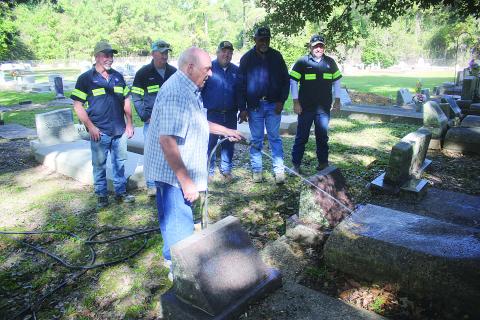 Roy Viscardis, the caretaker of Beaver Creek Cemetery, is pictured as he washes off a grave. Pictured from left behind him are Todd Sharpe, Robert Coker, Evangeline Parish Police Juror Tim Causey, Michael George, and Randall King. Not pictured is Farron Gordon. (Gazette photo by Tony Marks)
