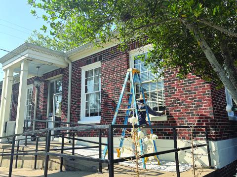 A crewmember is pictured as he works on the front exterior of the building that houses the Evangeline Chamber of Commerce and Evangeline Parish Tourist Commission. The work is through a grant program that was announced during the Ville Platte City Council meeting held Tuesday, May 12. (Gazette photo by Tony Marks)