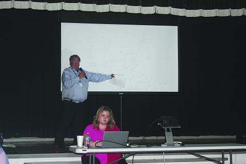 Standing is Michael Simms, Ph. D. (geology, hydrogeology) as he points out the location of the three currently proposed sites for carbon dioxide sequestration in Allen Parish. Seated is Emily Welch, who served as the moderator during the public hearing held Monday, April 28. (LSN photo by Tony Marks)