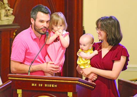 The Stansbury Family, Ryan and Sophie and their daughters Cecilia and Charlene, address the crowd at the annual Charlene Richard Mass. The family prayed to the “The Little Cajun Saint” for a healthy birth of their daughter Charlene. (LSN photo by Claudette Olivier)