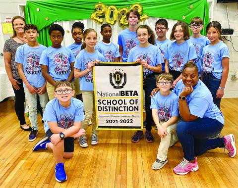 CHATAIGNIER BETA CLUB RECEIVES HONOR - Members of the Chataignier Beta Club gather around the banner. Kneeling in front are Parker Bertrand, and Korbin Fontenot and sponsor Sherelene Johnson. In the center holding the banner are Brooklyn Soileau, left; and Layla Boudreaux, right. Standing in back, from left, are assistant principal Leslie DesHotels, Liam Celestine, Sterling Coleman Jr., Jillian Malbrew, Sage Papillion, Ty Ardoin, Peyton Thibodeaux, Sadie LeBleu, Mika Thibodeauux and Jordyn Manuel. 