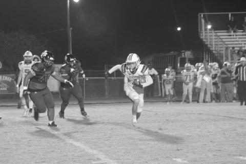 Cayden Fontenot (4) looks for daylight between him and a couple of Church Point defenders in Pine Prairie’s 54-14 loss in the district opener. (Gazette photo by Rhett Manuel)