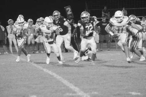 Gavin Patin (22) gains rushing yards for Sacred Heart in the Trojans’ 48-36 win over Metairie Park Country Day last week (Gazette photo by Tony Marks)