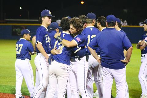 ALL HUGS  -  Members of the Sacred Heart baseball team gather on the field as senior Boyce Schexnider (13) and freshman John Aaron Soileau (10) share a hug after their quarterfinal loss against Covenant Christian. (Gazette photo by Tony Marks)