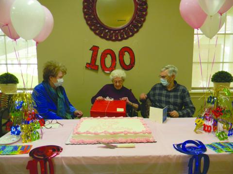 GIFTS FOR THE BIRTHDAY GIRL - Hattie Pouncey opens her gifts as her son Greg Fontenot, right and daughter-in-law Sharon Fontenot, right, look on. (Gazette photo by Heather Bogard)