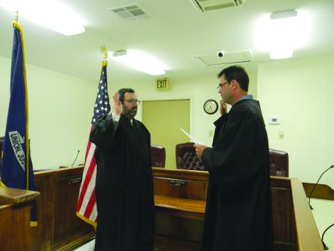 Jacob Fusilier (left) takes the oath of office as new magistrate for the Town of Mamou. Administering the oath is Fusilier’s predecessor Marcus Fontenot (right) who was elected as district judge in Division A for the 13th Judicial Court. For more photos, turn to Page 10. (Gazette photo by Heather Bogard)