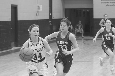 Taylor Darbonne (34) drives past a St. Edmund defender on her way to the goal in  Sacred Heart’s district clinching 30-23 win over the Lady Blue Jays on Tuesday night. (Gazette photo by Rhett Manuel)