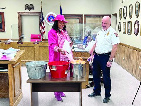 OCTOBER 13 - Ville Platte Mayor Jennifer Vidrine (left) and Fire Chief Chris Soileau (right) set fire to four bonds signifying the closure of the city’s nearly $9 million in debt. Also pictured in the back are Councilmembers Jerry Joseph and Christina Sam. (Gazette photo by Nancy Duplechain)