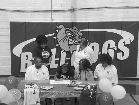 Destiny Lavigne (seated center left) is pictured as she signs to play college softball with Xavier University of Louisiana. Also pictured (from left) are standing Ville Platte High School Principal Shelsy Williams and former Ville Platte High School Assistant Principal Dawn Bellard; seated- Ville Platte High School Softball Coach Devinskie Arvie, Latoya Lavigne, and Ville Platte High School Assistant Coach Shonda Jack.