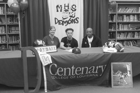 Devin Ardoin (center) is pictured as he signs to play college football at Centenary College of Louisiana in Shreveport. Also pictured are his mother, Natalie Ardoin, on the left, and his father, Sentell Ardoin, on the right. (Gazette photo by Tony Marks)
