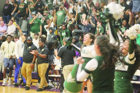 Members of the Mamou coaching staff and cheerleading squad, as well as other member of the Mamou community, celebrate after the Mamou Green Demons advanced to the state semifinals. With the win, the team moved on to play Marksville on Wednesday, March 11, at Burton Coliseum in Lake Charles. (Gazette photo by Tony Marks)