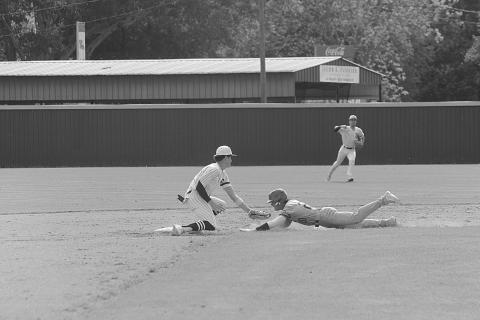 Rightfielder Wade Pitre (24) gives a celebratory fist bump as second baseman Hayden Droddy (9) retires a Catholic-Pointe Coupee runner on the base paths in Sacred Heart’s extra inning 4-2 loss on Monday, April 10. (Gazette photo by Rhett Manuel)