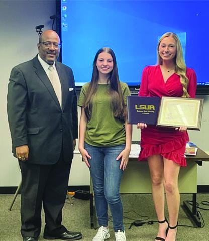Superintendent Darwan Lazard is pictured on the left with Kaylie Granger (center), of Mamou High School, and Harlie Arnaud (right), of Pine Prairie High School. The students earned their dual enrollment associate degrees. Not present for the school board meeting on Wednesday, May 17, were Hanna Claire Manuel, Alli Chaumont, and Madison Forestier, of Basile High School. (Gazette photo by Tony Marks)