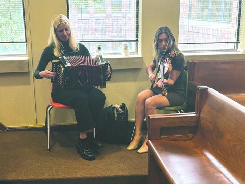 Juliane Mahoney (left) and Renee Reed (right), of The Holiday Playgirls, perform during the French meeting held Tuesday, December 10. (Gazette photo by Tony Marks)