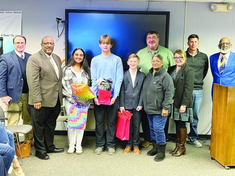 From left are: back row- Evangeline Parish School Board members Mike Fontenot, Nick Chaumont, and Donald Anderson; front row- Assistant Superintendent Mike Lombas, Superintendent Darwan Lazard, 12th grade Student of the Year Prisha Makey, 8th grade Student of the Year Reed Cormier, 5th grade Student of the Year Emmett Christ, EPSB Vice President Sheila Joseph, and Elementary Supervisor Cherie Fontenot. (Gazette photo by Tony Marks)