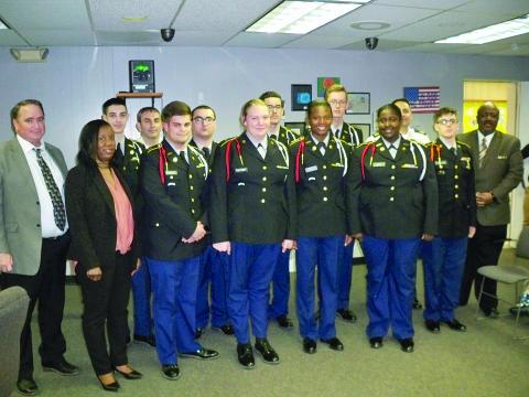 Pictured from left are (front row) Assistant Superintendent of Schools Michael Lombas, Ville Platte High Principal Chenile Tezeno, Riley Manuel, Tiffany Fontenot, Passion Lemelle, Carla Leday, Tyler Donaldson, and Superintendent of Schools Darwan Lazard; (back row) Jeremiah Manuel, Captain Jared Ski Doucet, Donald Keemun, Julian Salazar, Brennan Trosclair, and First Sergeant Jesse Fontenot. (Gazette photo by Tony Marks)