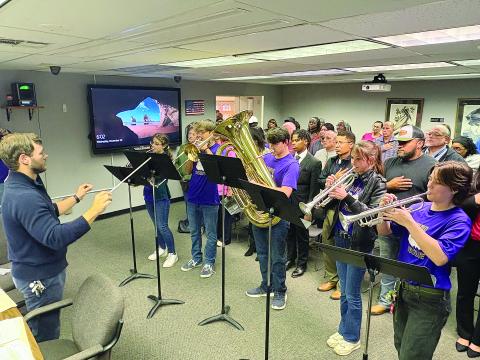 John Havard (left) conducts as members of the Pine Prairie High School Marching Band perform the National Anthem at the Evangeline Parish School Board meeting held Wednesday, November 20. From left are Kelly Monier, Camren Vidrine, Collin Vidrine, Adyson West, and Sarah Sullivan. (Gazette photo by Tony Marks)