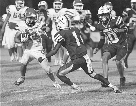 Basile High’s Logan Bergeron (22) attempts to get around Elton defenders in the season opener between the Basile Bearcats and the Elton Indians. (Photo by Tonya Ortego)