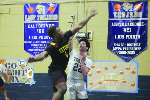 Nolan Johnson (22) manages to get off a shot from the court in Sacred Heart’s 44-36 win over Elton last Friday at home. (Gazette photo by Tony Marks)