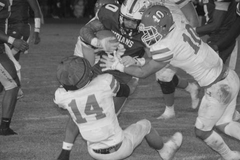 Pierson Comeaux (14) and Carter Darbonne (10) look to make a tackle against an Elton runner in Basile’s playoff loss last Friday. (LSN photo by Rhett Manuel)