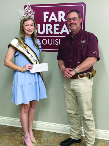 NEW QUEEN CROWNED - During the March board meeting of the Evangeline Parish Farm Bureau held March 14, Emily Deshotel was crowned as the 2022 Evangeline Parish Farm Bureau Queen. She is shown with Farm Bureau President David Scott “Scotty” Fontenot. (Photo courtesy of Kristie Mayeux)