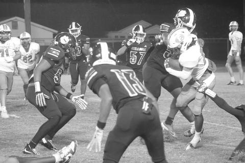 Members of the Ville Platte defensive unit, including Keith Doucet (55) attempt to make a stop against a Eunice ball carrier. (Gazette photo by Tony Marks