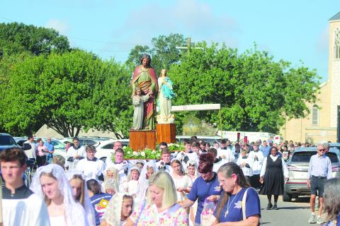 Statues of St. Joseph and the Blessed Virgin Mary proceed ahead of Jesus in the Blessed Sacrament as a foot procession is held from St. Leo the Great Catholic Church to the boat landing on the Bayou Teche in Leonville as part of the Fête-Dieu du Teche Eucharistic Boat Procession on Saturday, August 15. (Gazette photo by Tony Marks)