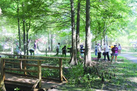 Several volunteers are pictured as they help clean up the Ville Platte Native Plant Heritage Garden on Saturday, August 5. (Gazette photos by Tony Marks)