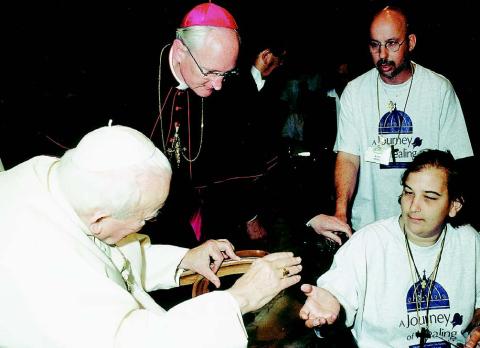 MEETING THE POPE - Nicole Lynn Soileau, the daughter of Harold Soileau and Fannie Soileau, both of Ville Platte, recently took part in a pilgrimage where she got the chance to meet Pope John Paul II in Rome. Nicole is shown here with the Pope. Also shown is her assistant, Keith Delano of Abbeville, back right.