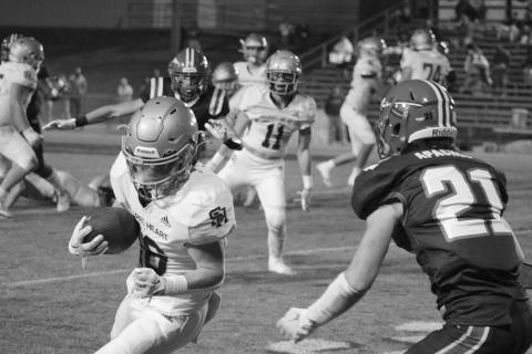 Boyce Schexnider (16) looks for yards after the catch in Sacred Heart’s playoff loss to Glenbrook School last Friday night. (Gazette photo by Tony Marks)