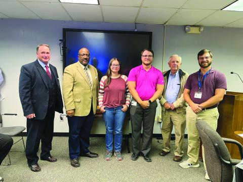 PINE PRAIRIE STUDENT RECOGNIZED - Grace Bordelon, a senior at Pine Prairie High School, was recognized for being the only student to make the top state symphonic honor band. She is shown with, from left, Assistant Superintendent Mike Lombas, Superintendent Darwan Lazard, Pine Prairie Band Director John Havard, School Board President Wayne Dardeau and Pine Prairie Talented Music/Percussion Director Taylor Naquin. (Gazette photo by Heather Bogard)