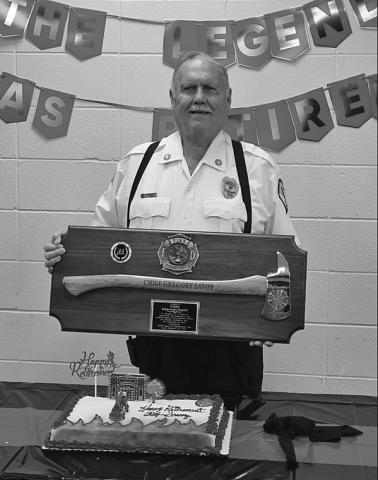 Acadia-Evangeline Fire Chief Greg Savoy shows off his retirement plaque.
