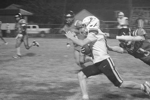 Jacob Carroll (5) breaks a would be tackle for a big gain in Pine Prairie’s 50-42 loss to Gueydan. (Gazette photo by Tony Marks)